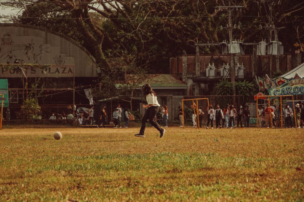 a girl playing soccer on a field